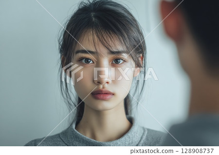 Close-up portrait of a woman looking across the screen Close-up portrait of a woman looking across the screen 128908737