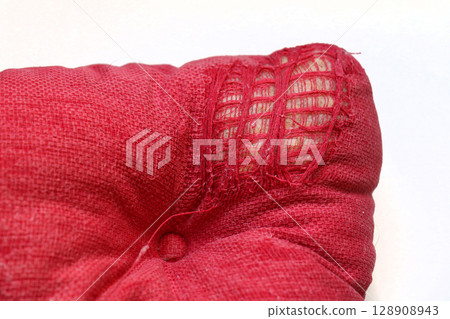 Torn up textile pillow corner 128908943