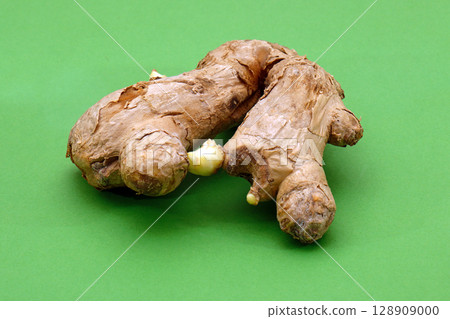 Organic ginger root on green 128909000