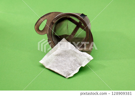 Tea bag inside metal strainer 128909381