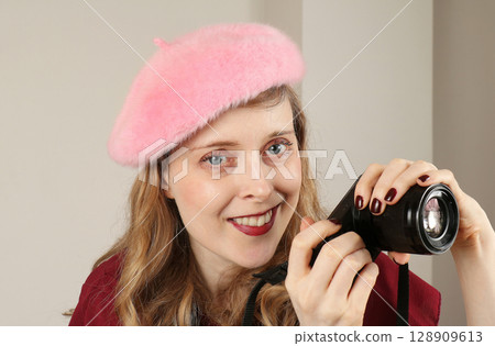 Young female photographer with camera Young female photographer with camera 128909613