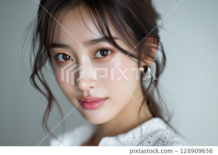 Natural portrait of a young woman looking straight ahead 128909656