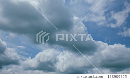 Stunning Dramatic Cloud Formations Under a Bright Blue and Expansive Sky Above You 128909825