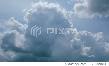 Dynamic and Stunning Cloud Patterns Forming Beautifully in a Clear Blue Sky Above 128909881