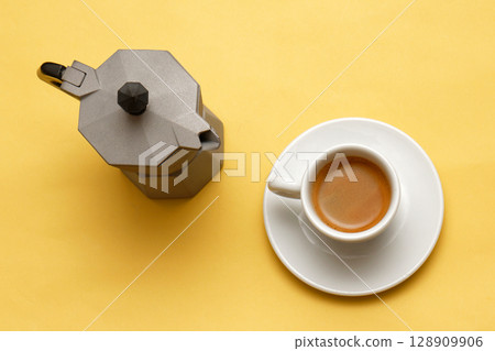 Italian coffee pot with espresso in cup Italian coffee pot with espresso in cup 128909906