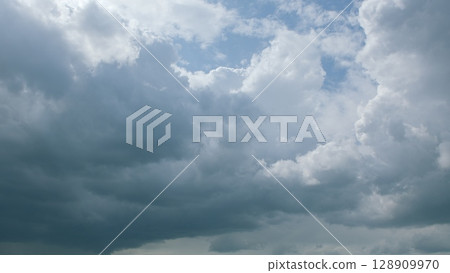 A Stunningly Dramatic Cloudy Sky Filled with Beautiful Shades of Grey and Blue Tones A Stunningly Dramatic Cloudy Sky Filled with Beautiful Shades of Grey and Blue Tones 128909970
