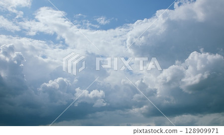 The sky is a beautiful canvas with dramatic cloud patterns that captivate observers 128909971