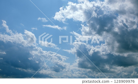 A Beautiful Cloudy Sky That Exists Under the Bright Rays of Sunlight This Afternoon 128909976