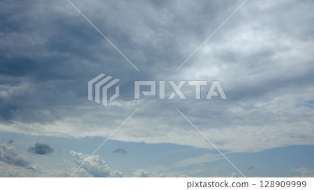 A Dramatic Cloudy Sky Displaying Rich Shades of Blue and Gray, An Incredible View 128909999