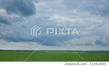 A serene and peaceful landscape featuring a dynamic and everchanging cloudy sky 128910005