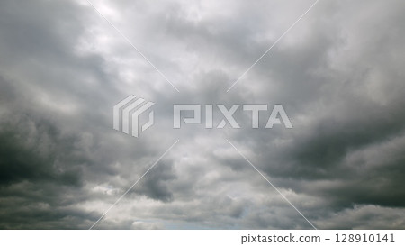 Dramatic Cloudy Sky with Various Shades of Gray Tones and Intriguing Patterns Above Dramatic Cloudy Sky with Various Shades of Gray Tones and Intriguing Patterns Above 128910141