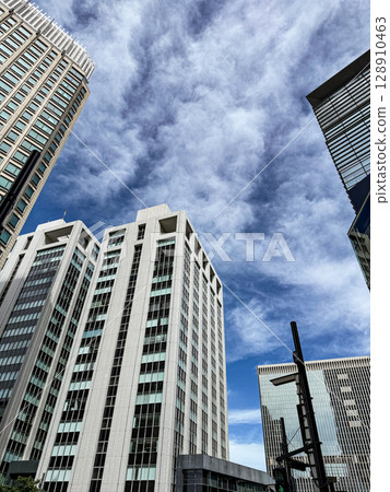 Clouds and sky reflected on the building Clouds and sky reflected on the building 128910463