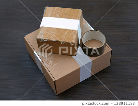 Packaging boxes on wooden background Packaging boxes on wooden background 128911158