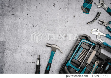 Set of tools on concrete background, 128911332