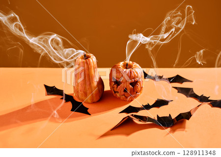 Halloween-style candles on a orange background. Festive decor. 128911348
