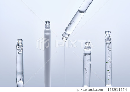 Five different droppers with facial serum in a row. 128911354
