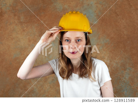 Young woman with protective helmet Young woman with protective helmet 128911589
