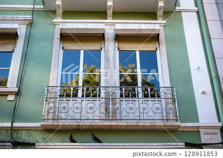 Building Facade with Balcony and Window Reflections Building Facade with Balcony and Window Reflections 128911853