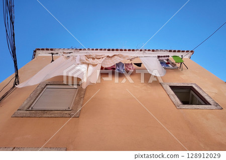 Laundry Day on a Sunny Building Exterior Laundry Day on a Sunny Building Exterior 128912029