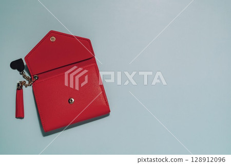 Open Red Wallet with Tassel Keychain on Blue 128912096