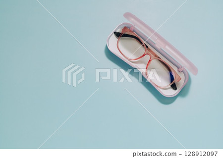Pink Glasses in Open Case on Blue, Vision and Protection 128912097