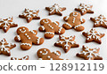 Christmas cookies: gingerbread cookies in the shape of people and stars, decorated with white icing. 128912119