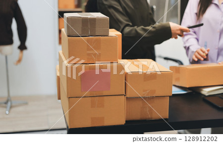 Portrait of Starting small businesses SME owners, two Asian woman check online orders Selling products working with boxs freelance work at home office, sme business online small medium enterprise 128912202