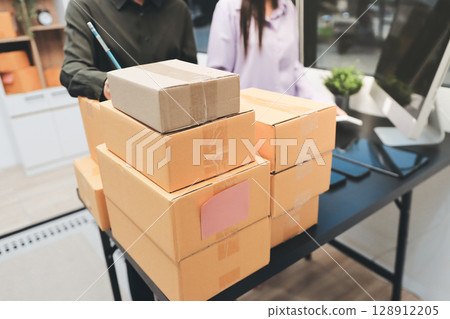 Portrait of Starting small businesses SME owners, two Asian woman check online orders Selling products working with boxs freelance work at home office, sme business online small medium enterprise Portrait of Starting small businesses SME owners, two Asian woman check online orders Selling products working with boxs freelance work at home office, sme business online small medium enterprise 128912205