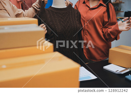 Portrait of Starting small businesses SME owners, two Asian woman check online orders Selling products working with boxs freelance work at home office, sme business online small medium enterprise Portrait of Starting small businesses SME owners, two Asian woman check online orders Selling products working with boxs freelance work at home office, sme business online small medium enterprise 128912242