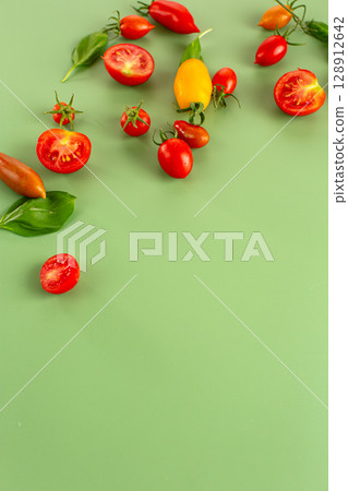 Bright summer vegetables with basil on mint background 128912642