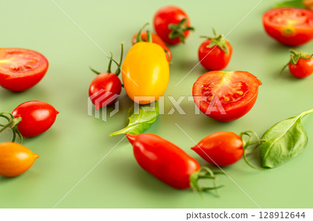 Colorful tomatoes composition with basil leaves minimal style 128912644