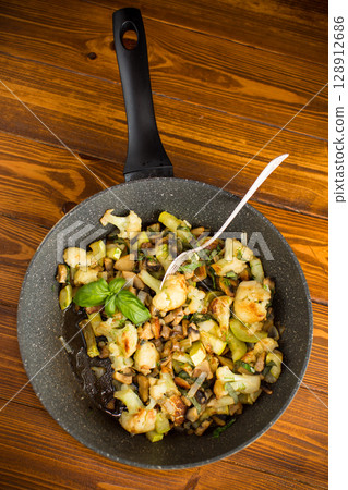 Vegetarian dish with cauliflower, zucchini and mushrooms Vegetarian dish with cauliflower, zucchini and mushrooms 128912686