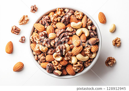 Healthy mix of almonds, walnuts and cashews in a white bowl. 128912945