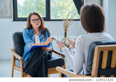 Female mental health professional working with young woman Female mental health professional working with young woman 128913320