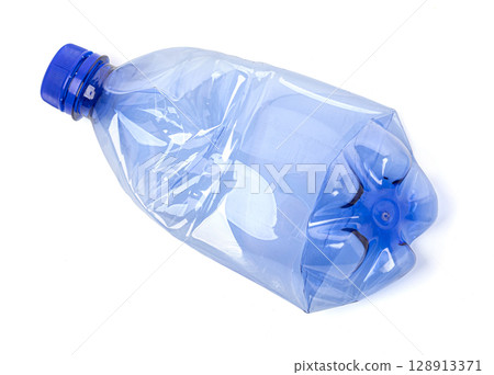Used crushed blue plastic bottle with blue cap isolated on white background Used crushed blue plastic bottle with blue cap isolated on white background 128913371