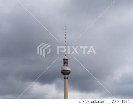 Berlin. Germany. 07.26.2025 The top of the Berlin TV Tower (Fernsehturm) with its antenna against a dramatic cloudy sky. Berlin. Germany. 07.26.2025 The top of the Berlin TV Tower (Fernsehturm) with its antenna against a dramatic cloudy sky. 128913935
