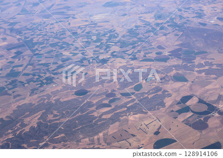 Aerial View of Agricultural Fields and Circular Irrigation Systems in Rural Landscape 128914106