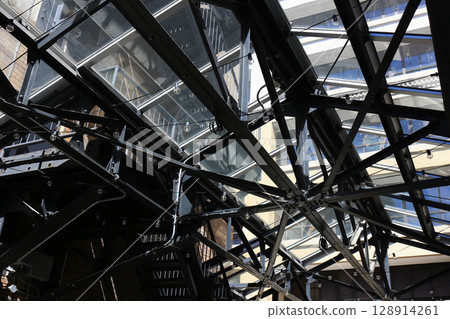 A black painted steel warehouse with a glass roof A black painted steel warehouse with a glass roof 128914261
