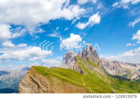 Explore the scenic Seceda ridgeline trail in the Italian Dolomites. 128915079