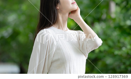 A woman standing in fresh green 128917369