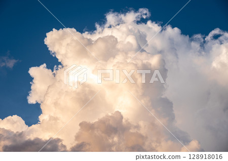 Cumulonimbus clouds appear on the sky. Cumulonimbus clouds almost always signal that there is a thunderstorm happening. 128918016