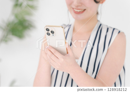 A woman watching a smartphone A woman watching a smartphone 128918212