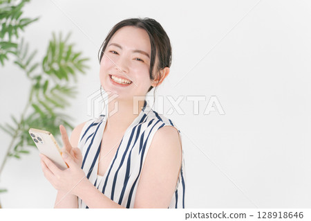 A woman watching a smartphone A woman watching a smartphone 128918646