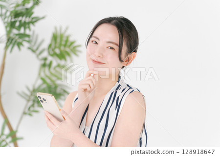 A woman watching a smartphone A woman watching a smartphone 128918647
