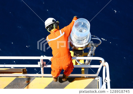 Technician repaired and replaced equipment on oil and gas platform, Performed preventive maintenance and corrective maintenance equipment of oil and gas platform, Safety condition concept. Technician repaired and replaced equipment on oil and gas platform, Performed preventive maintenance and corrective maintenance equipment of oil and gas platform, Safety condition concept. 128918745