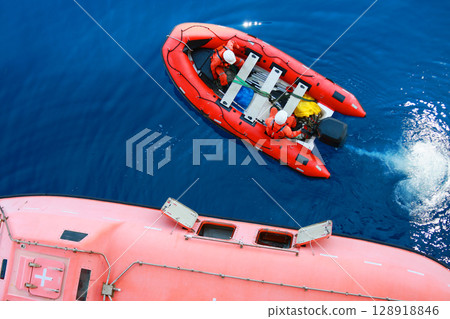 Life boat in gulf or sea to support oil and gas platform, Safety equipment to protect worker when fire case in oil and gas industry, Evacuation equipment in and and gas platform, Safety equipment Life boat in gulf or sea to support oil and gas platform, Safety equipment to protect worker when fire case in oil and gas industry, Evacuation equipment in and and gas platform, Safety equipment 128918846