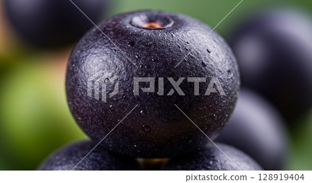 Close-up of a fresh, dark berry covered in water droplets. Healthy and vibrant. Close-up of a fresh, dark berry covered in water droplets. Healthy and vibrant. 128919404