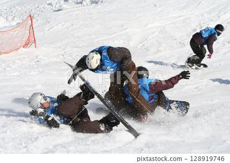 Snowboarder falls during snowboardcross Snowboarder falls during snowboardcross 128919746