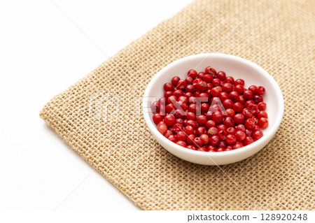 Pink pepper on a white background Pink pepper on a white background 128920248