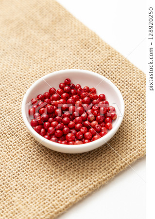 Pink pepper on a white background 128920250